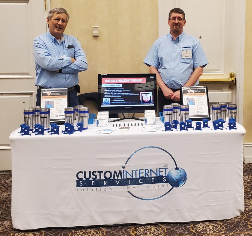 David and Steve setup at a conference, promoting our services